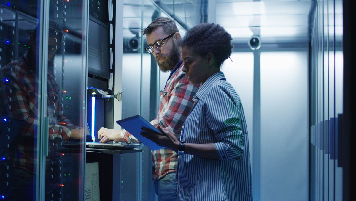 Man and woman standing in a data center